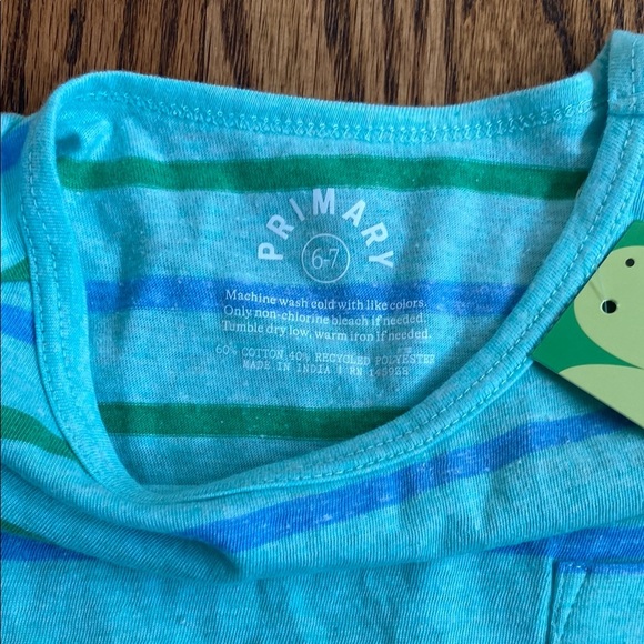 New with tag, blue and green striped Primary dress size 6-7. Ships quickly. - Picture 2 of 7